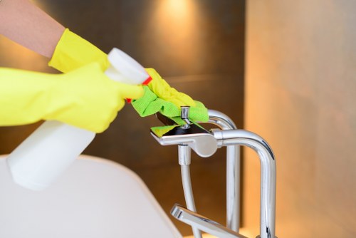 Kitchen surfaces being cleaned during domestic cleaning in Finsburypark
